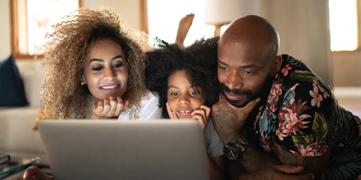 young family viewing laptop